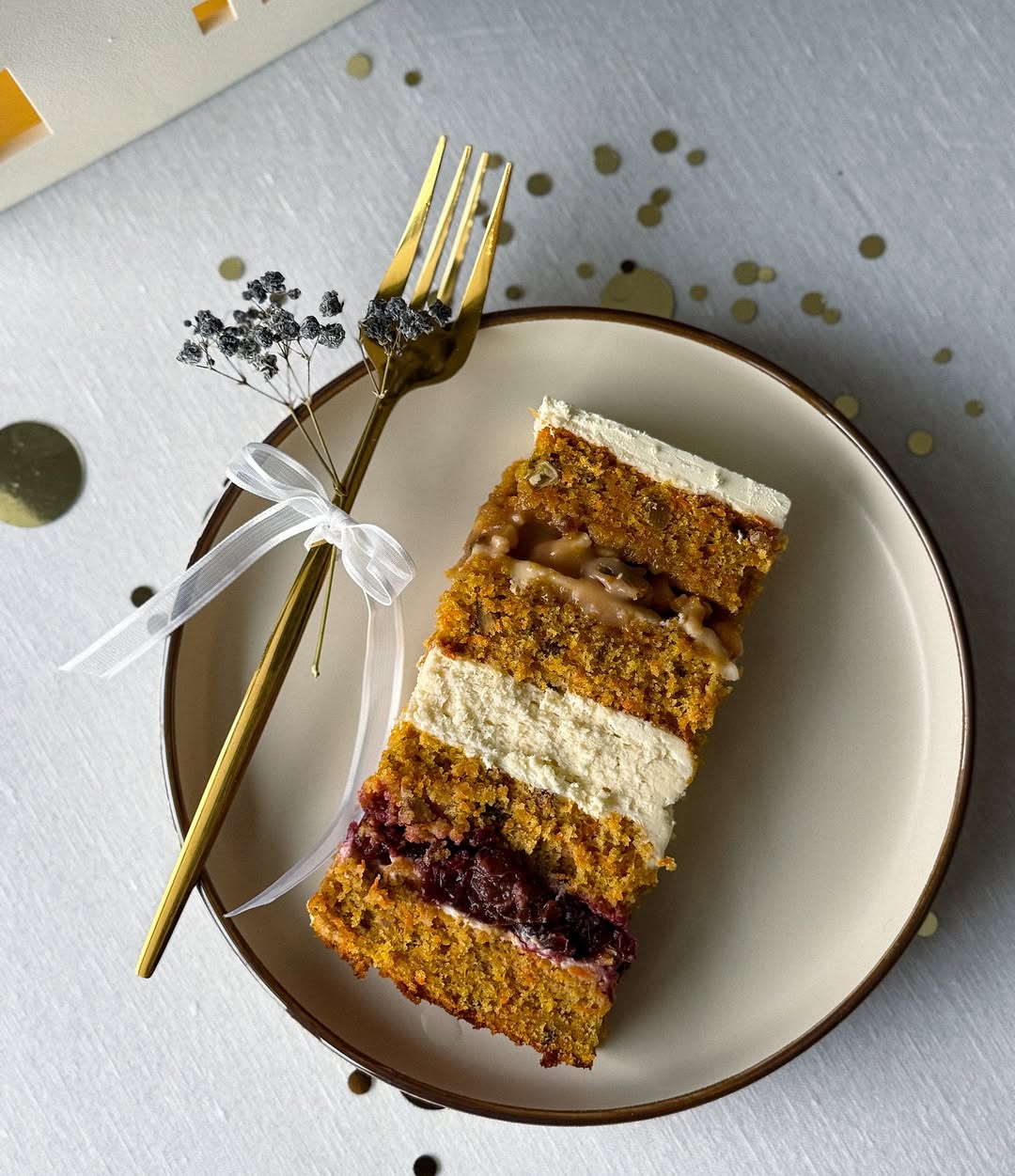 Three-tier wedding cake with gold accents